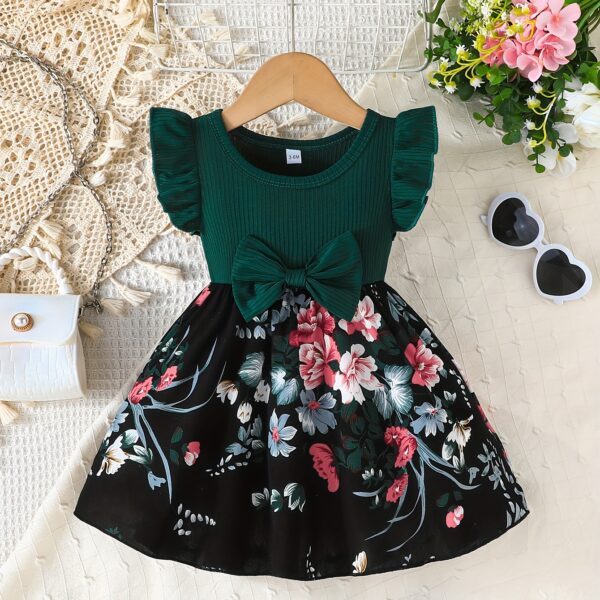 Adorable girl wearing a vibrant Summer Bloom floral print dress, perfect for summer. The dress features a playful, colorful floral pattern.