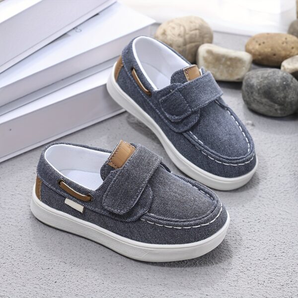 Stylish and comfortable blue canvas shoes for boys, perfect for everyday wear. The shoes feature a classic design with a touch of modern style.