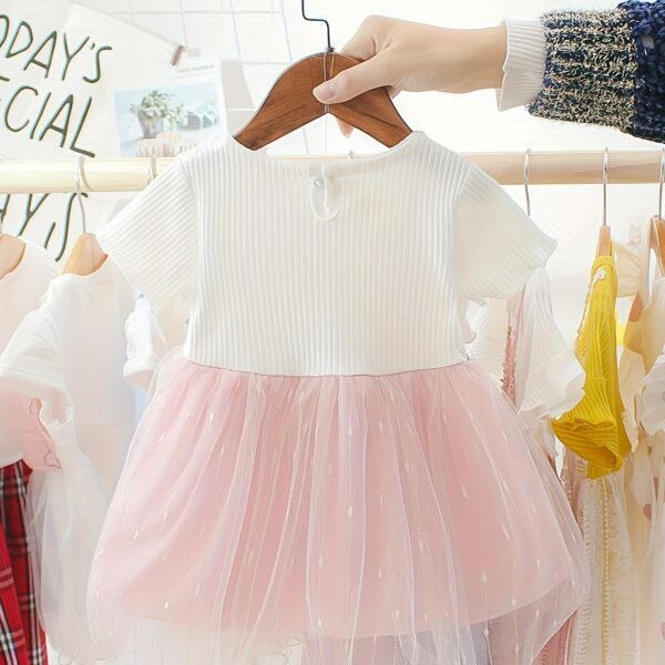 Adorable little girl twirling in a pink Summer Bloom Rose Princess Dress from Newness, showcasing its comfortable and stylish design.