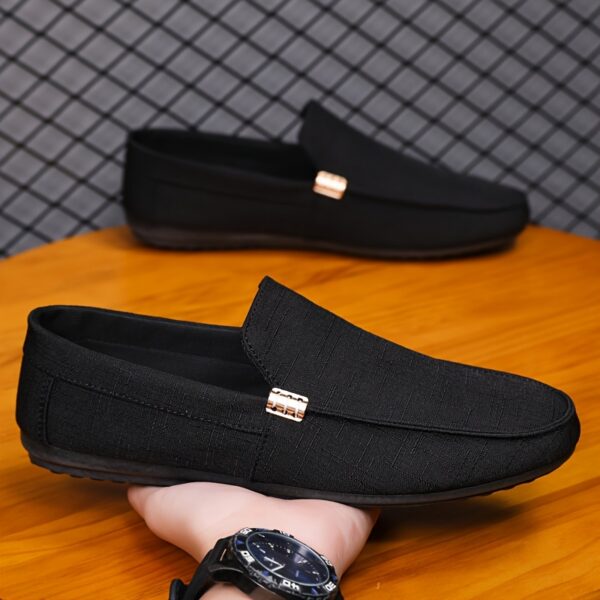 Newness Metropolitan Mens Slip On Loafers in classic black featuring breathable fabric a durable PU sole and stylish golden accents Perfect for everyday wear