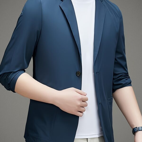 A man wearing the Newness Lightweight Breeze Men's Summer Blazer, looking effortlessly stylish in a summer setting.