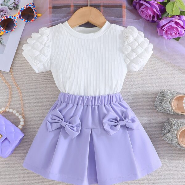 Adorable Pastel Dream Girls' Summer Set featuring a pastel-colored top and bottom, perfect for summer. The outfit is shown on a young girl, highlighting its comfortable and stylish design.