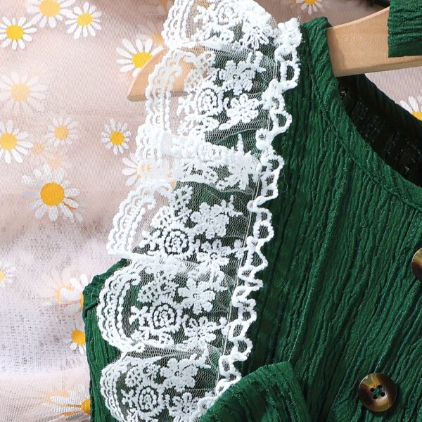 Toddler girl wearing a charming emerald green summer dress, ideal for playing outdoors.