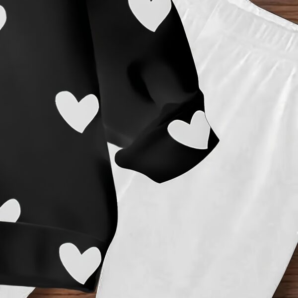Adorable girls' playful set featuring a sweet heart print, perfect for fall and winter. The outfit includes [mention pieces included, e.g., a sweater and leggings] in soft, comfortable fabrics.