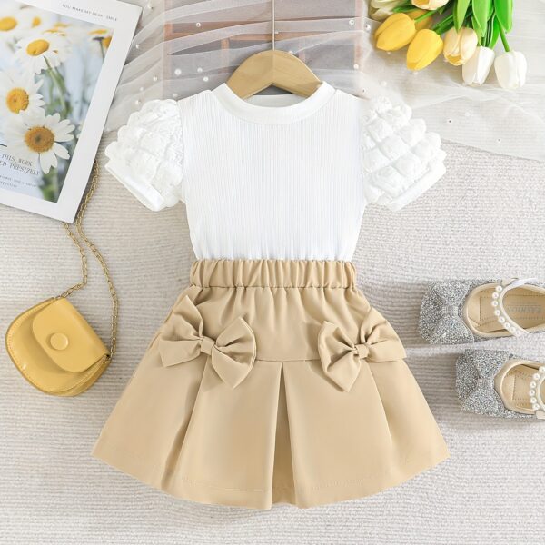 Adorable Pastel Dream Girls' Summer Set featuring a pastel-colored top and bottom, perfect for summer. The outfit is shown on a young girl, highlighting its comfortable and stylish design.
