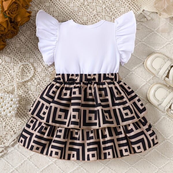 Baby girl wearing a charming two-tone plaid summer dress, perfect for playtime.