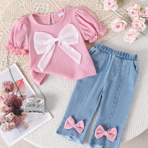 Adorable toddler girl in a stylish summer outfit featuring a cute bow Shop Newness for more childrens fashion