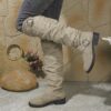 Newness Slouchy Knee High Boots in brown leather showcasing a chic and casual style perfect for winter The boots are slouchy and knee high highlighting their comfortable and fashionable design