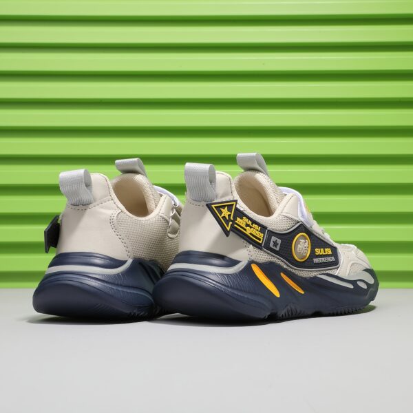 Stylish striped mesh youth sneakers, perfect for active kids. Breathable and comfortable design in a trendy color scheme.