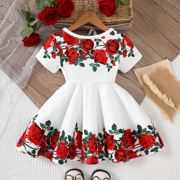 Adorable baby girl wearing a Rosalind floral print dress from Newness. The dress features a charming floral pattern and is perfect for special occasions or everyday wear.