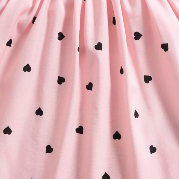 Girl wearing adorable Summer Bloom heart print dress and matching hat set.