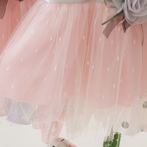 Adorable little girl twirling in a pink Summer Bloom Rose Princess Dress from Newness, showcasing its comfortable and stylish design.