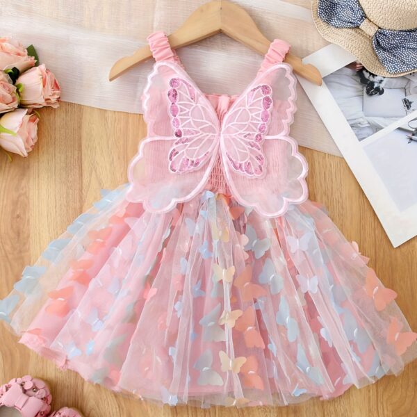 Adorable baby girl wearing a Flutterby Mesh Butterfly Dress, a perfect summer outfit from Newness.