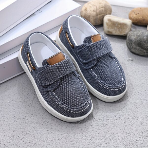 Stylish and comfortable blue canvas shoes for boys, perfect for everyday wear. The shoes feature a classic design with a touch of modern style.