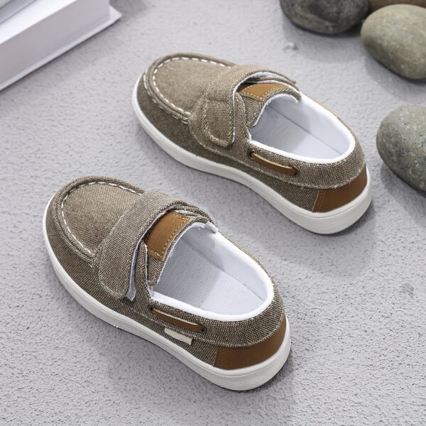 Stylish and comfortable blue canvas shoes for boys, perfect for everyday wear. The shoes feature a classic design with a touch of modern style.