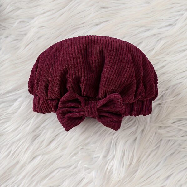 Adorable baby girl wearing a charming corduroy dress, perfect for playtime or special occasions.