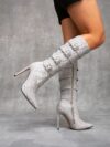 Newness Ascension Stiletto Buckle Boots Elevate your look with these stunning stiletto boots featuring a chic buckle detail