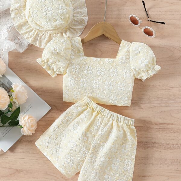 Adorable baby girl wearing a Summer Bloom floral outfit, perfect for summer. The outfit features a delightful floral pattern.