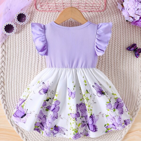 Adorable baby girl wearing a charming butterfly print dress from Newness, perfect for spring and summer.