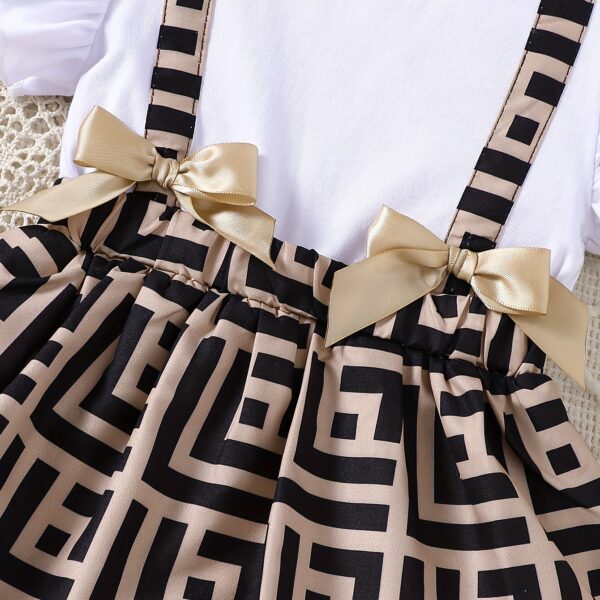 Baby girl wearing a charming two-tone plaid summer dress, perfect for playtime.