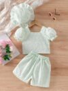 Adorable baby girl wearing a Summer Bloom floral outfit perfect for summer The outfit features a delightful floral pattern