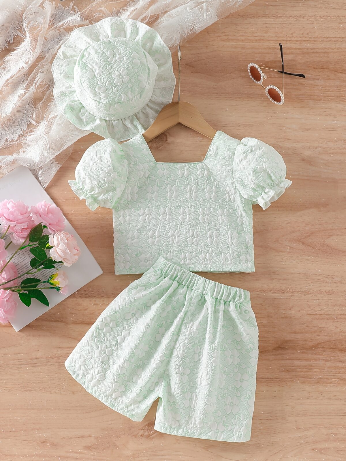 Adorable baby girl wearing a Summer Bloom floral outfit perfect for summer The outfit features a delightful floral pattern