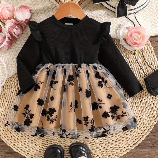 Baby girl wearing an adorable floral print dress, perfect for spring or autumn.