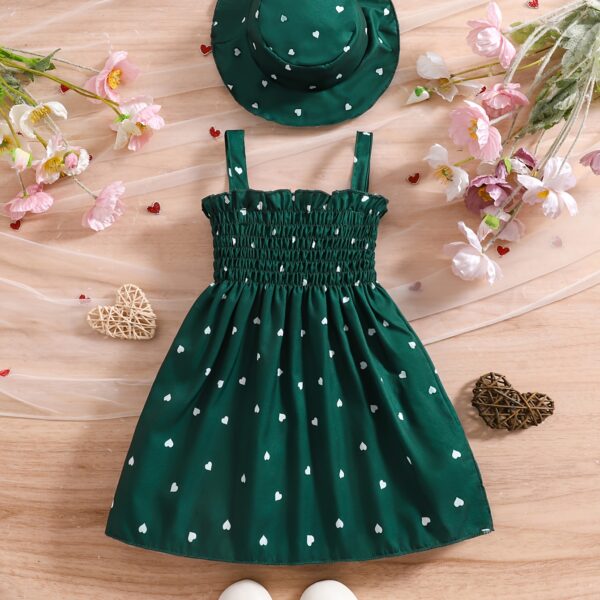 Girl wearing adorable Summer Bloom heart print dress and matching hat set.