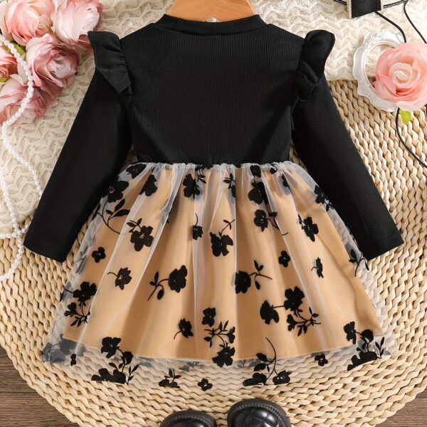 Baby girl wearing an adorable floral print dress, perfect for spring or autumn.