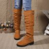 Newness Slouchy Knee High Boots in brown leather showcasing a chic and casual style perfect for winter The boots are slouchy and knee high highlighting their comfortable and fashionable design