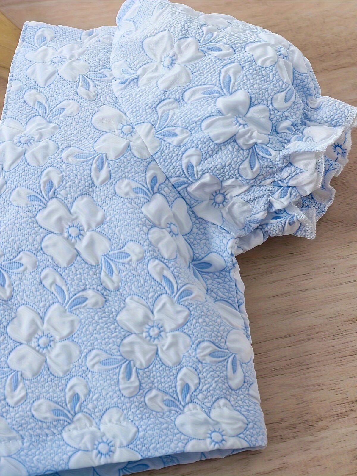 Adorable baby girl wearing a Summer Bloom floral outfit perfect for summer The outfit features a delightful floral pattern