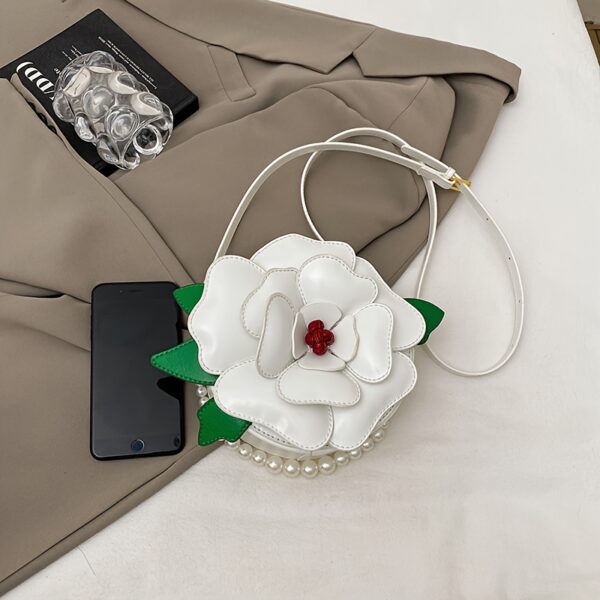 Camellia Blossom Floral Shoulder Bag from Newness, featuring a unique floral design, pearl accents, and an adjustable strap.