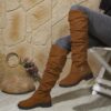 Newness Slouchy Knee High Boots in brown leather showcasing a chic and casual style perfect for winter The boots are slouchy and knee high highlighting their comfortable and fashionable design