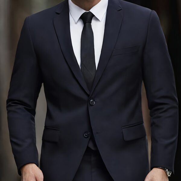 The Newness Metropolitan Men's Slim Fit Suit in charcoal grey, showcasing its sleek silhouette and impeccable tailoring on a sophisticated male model.