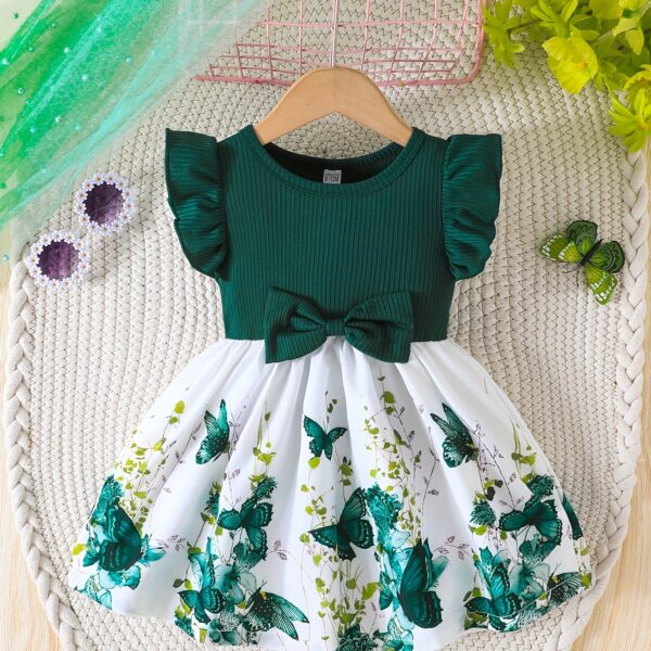 Adorable baby girl wearing a charming butterfly print dress from Newness, perfect for spring and summer.