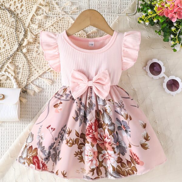 Adorable girl wearing a vibrant Summer Bloom floral print dress, perfect for summer. The dress features a playful, colorful floral pattern.