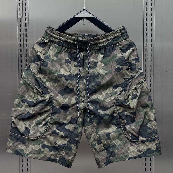 Model wearing Newness Tactical Camo Cargo Shorts, showcasing their loose fit and camo pattern. Ideal for summer adventures.