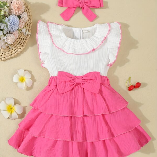 Adorable toddler girl in a vibrant Summer Bloom dress, perfect for summer adventures. The dress features a playful floral print and comfortable, breathable fabric.