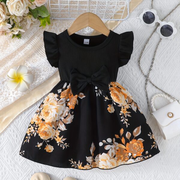 Adorable girl wearing a vibrant Summer Bloom floral print dress, perfect for summer. The dress features a playful, colorful floral pattern.