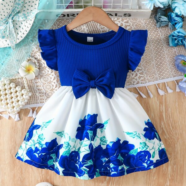 A little girl wearing a charming summer floral print dress.
