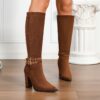Newnesss commanding chunky heel knee high boots in brown leather showcasing the side profile and heel