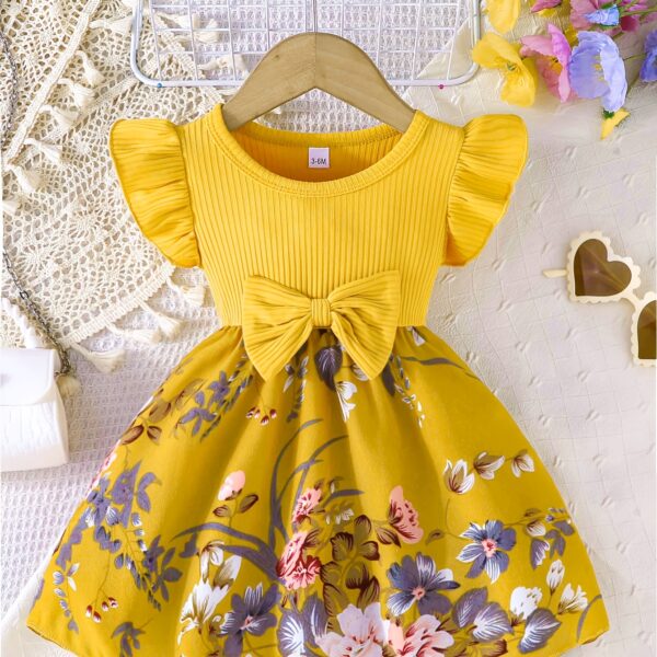 Adorable girl wearing a vibrant Summer Bloom floral print dress, perfect for summer. The dress features a playful, colorful floral pattern.