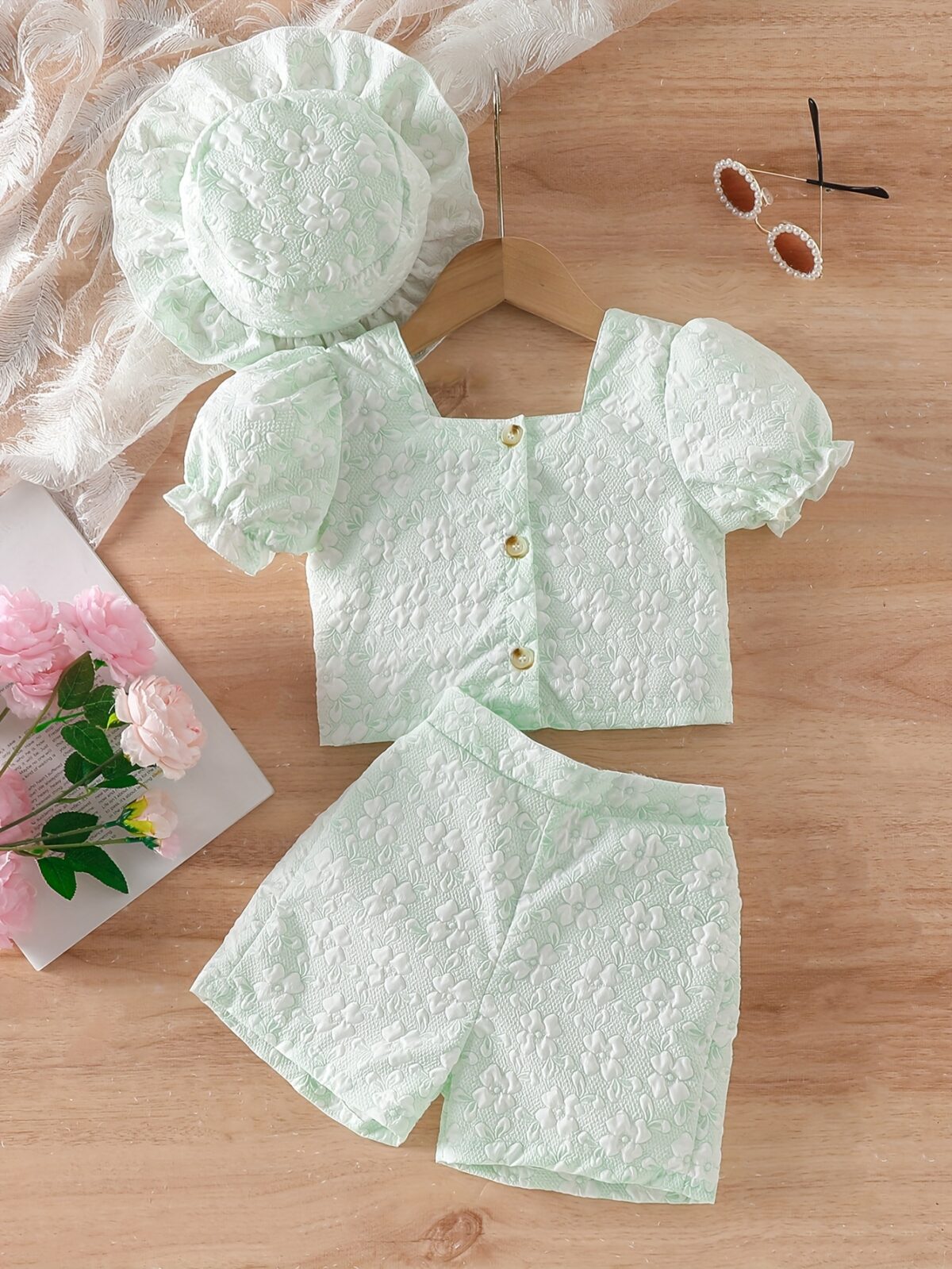 Adorable baby girl wearing a Summer Bloom floral outfit perfect for summer The outfit features a delightful floral pattern