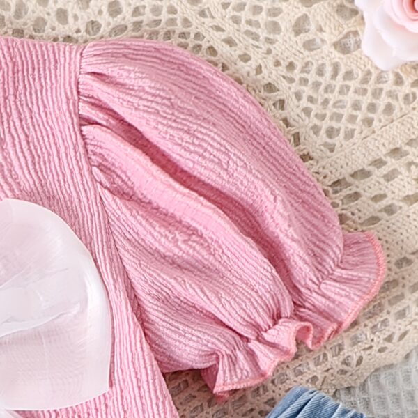Adorable toddler girl in a stylish summer outfit, featuring a cute bow. Shop Newness for more children's fashion.