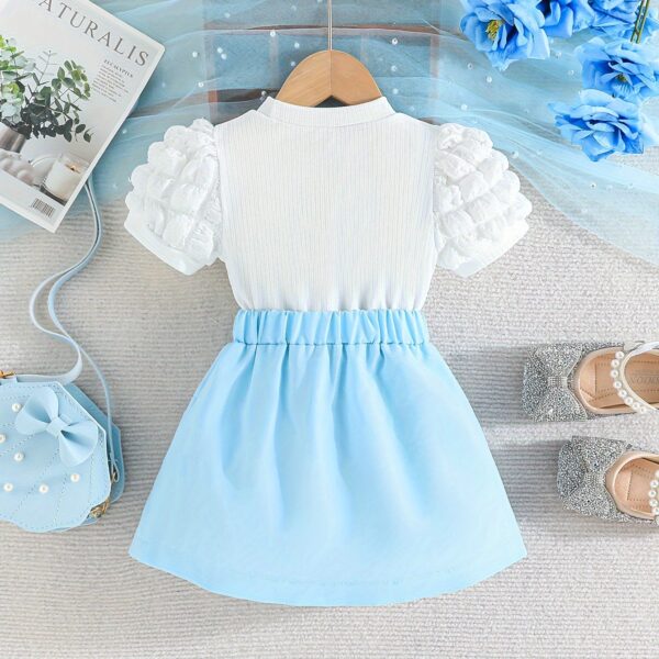 Adorable Pastel Dream Girls' Summer Set featuring a pastel-colored top and bottom, perfect for summer. The outfit is shown on a young girl, highlighting its comfortable and stylish design.