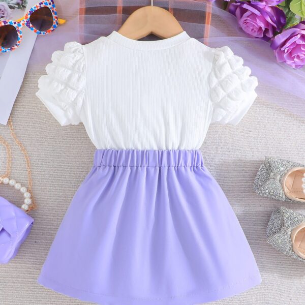 Adorable Pastel Dream Girls' Summer Set featuring a pastel-colored top and bottom, perfect for summer. The outfit is shown on a young girl, highlighting its comfortable and stylish design.