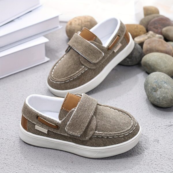 Stylish and comfortable blue canvas shoes for boys, perfect for everyday wear. The shoes feature a classic design with a touch of modern style.