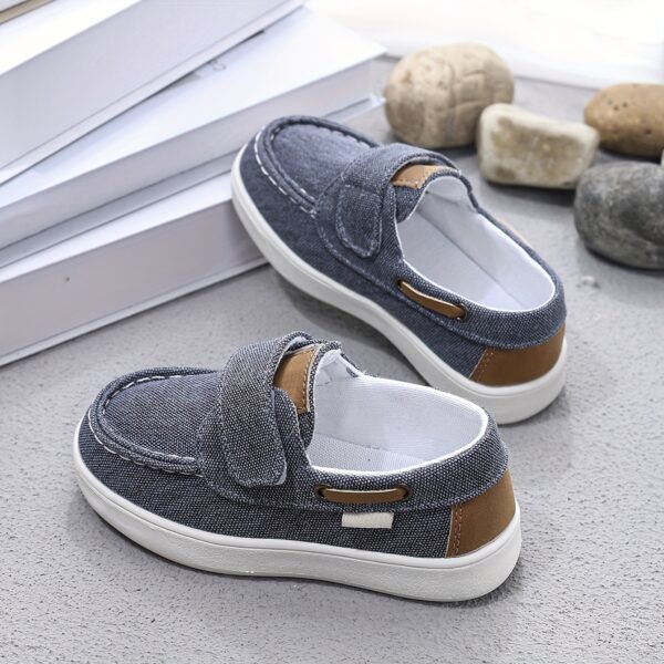Stylish and comfortable blue canvas shoes for boys, perfect for everyday wear. The shoes feature a classic design with a touch of modern style.