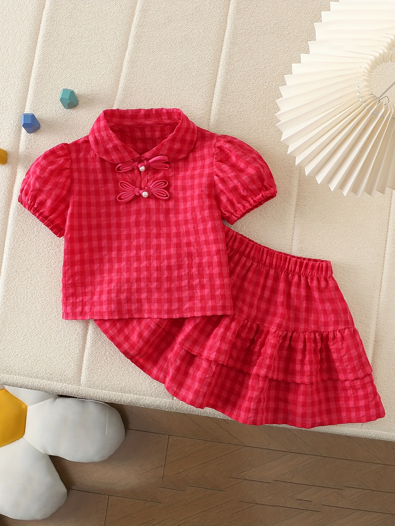 Adorable toddler girl wearing a charming Summer Bloom skirt set, perfect for summer playdates and outdoor fun. The set features a vibrant floral print and comfortable, breathable fabric.