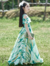 Adorable girl twirling in a flowy elegant chiffon dress perfect for summer The dress is in a beautiful summer garden setting